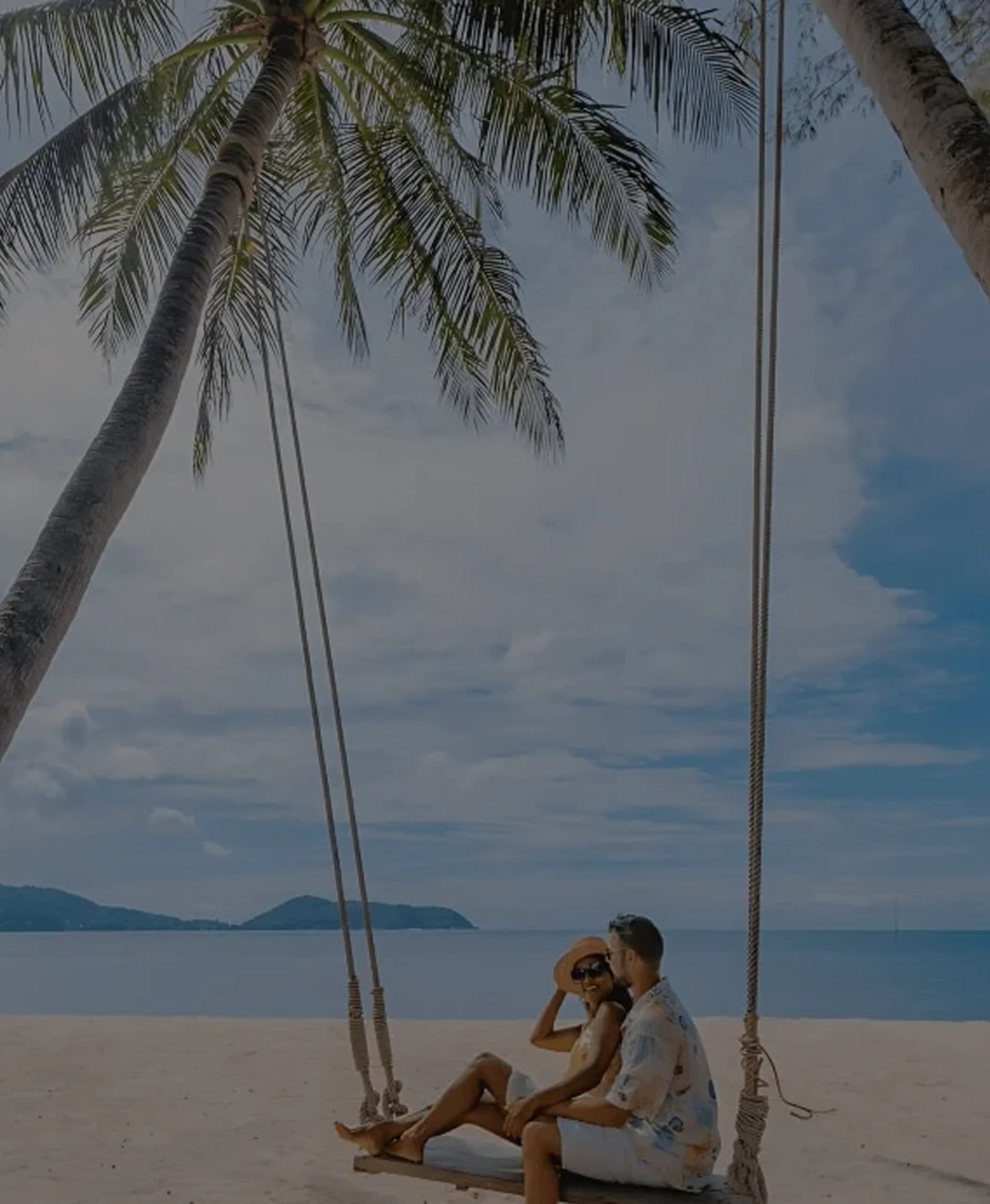 Couple relaxing on a beach swing